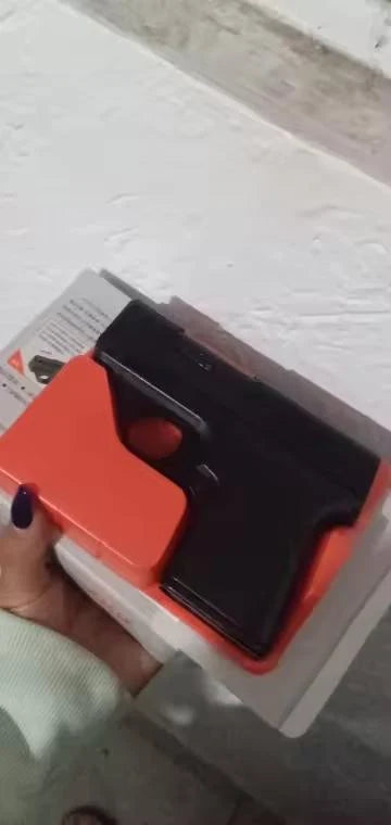 Black Puff-Shot torch lighter in its orange molded case