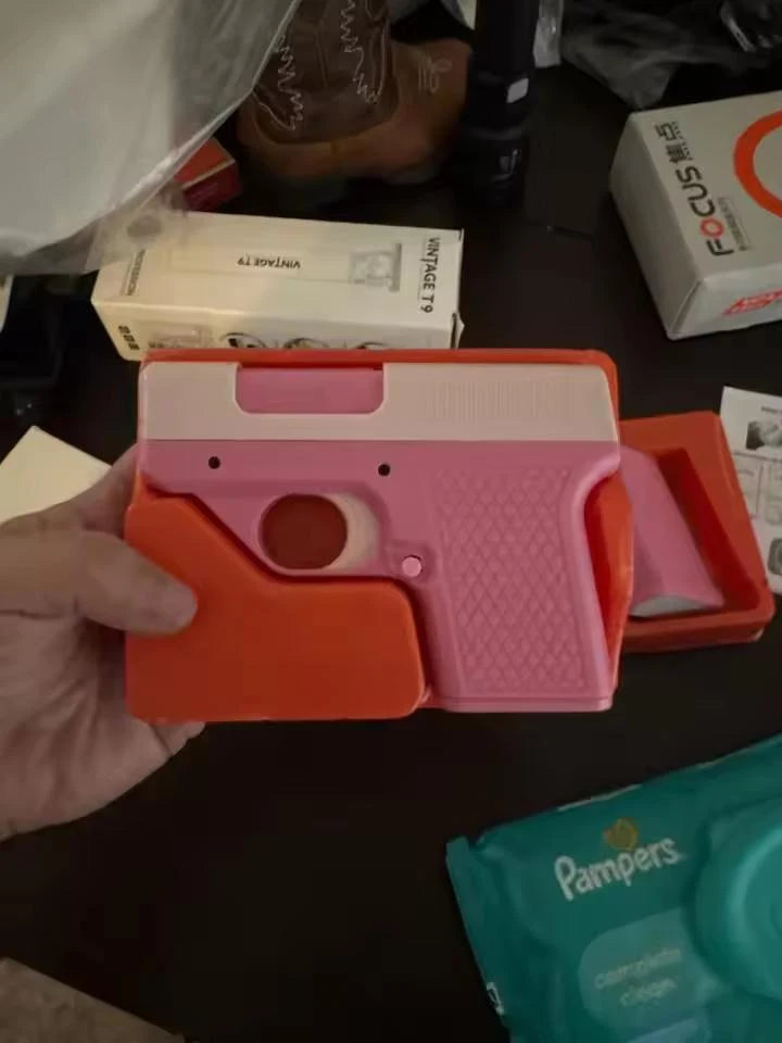 Pink Puff-Shot torch lighter in its orange molded case